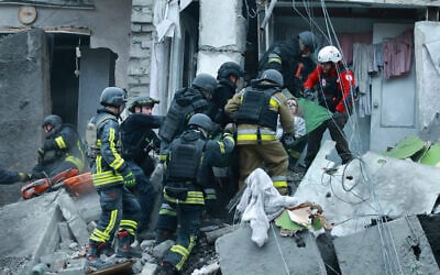Rescue workers pull a woman from the rubble of a residential building destroyed by a Russian airstrike in Zaporizhzhia, Ukraine, October 10, 2026. (AP Photo/Kateryna Klochko)