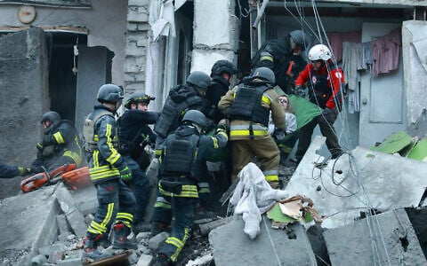 Rescue workers pull a woman from the rubble of a residential building destroyed by a Russian airstrike in Zaporizhzhia, Ukraine, October 10, 2026. (AP Photo/Kateryna Klochko)