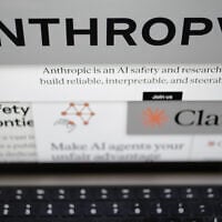 Pages from the Anthropic website and the company’s logos are displayed on a computer screen in New York, on February 26, 2026. (AP Photo/Patrick Sison)
