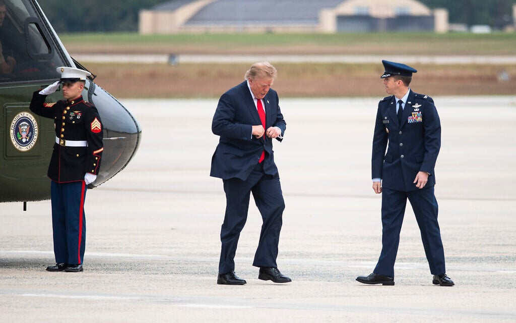 US President Donald Trump walks to board Air Force One with Col. Brandon Westling, Commander 89th Air Wing Group, right, at Joint Base Andrews, Maryland, October 10, 2026. (AP Photo/Cliff Owen)