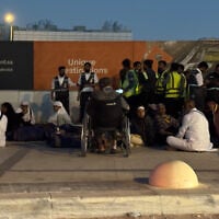 People gather outside a metro station on the road to King Khalid International Airport in Riyadh, Saudi Arabia, October 10, 2026. (AP)