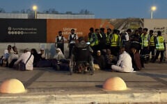 People gather outside a metro station on the road to King Khalid International Airport in Riyadh, Saudi Arabia, October 10, 2026. (AP)