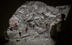 Palestinians inspect a building destroyed in an Israeli airstrike late Saturday in Zawaida, central Gaza Strip, October 11, 2026. (AP Photo/Abdel Kareem Hana)