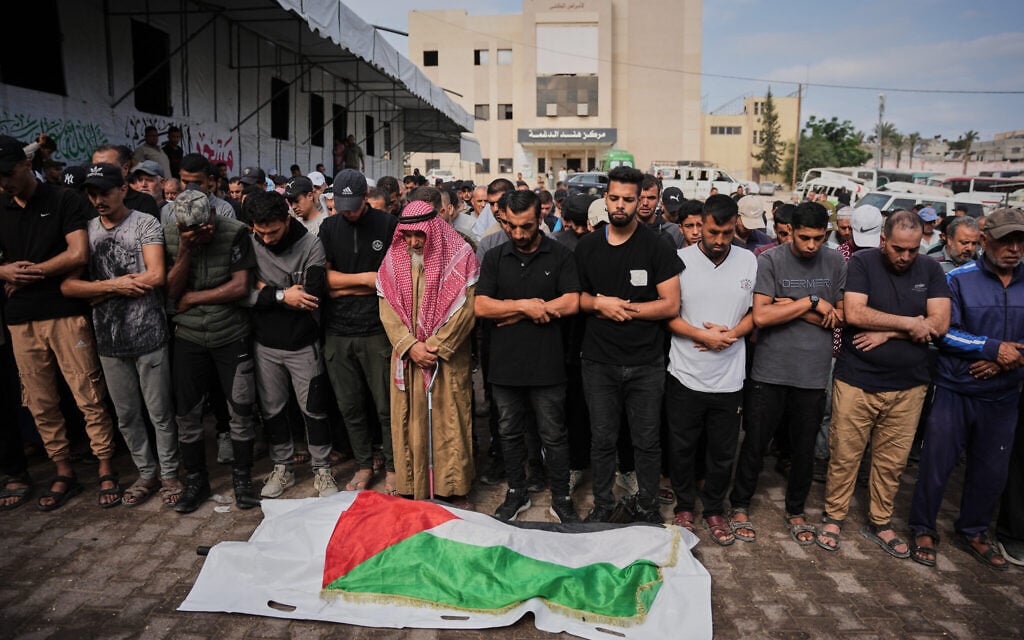 Mourners pray beside the body of Abdel Majid Jadallah, draped in a Palestinian flag, who was killed in Israeli military strikes, during his funeral at Nasser Hospital in Khan Younis, southern Gaza Strip, October 12, 2026. (AP Photo/Abdel Kareem Hana) Mourners pray beside the body of Abdel Majid Jadallah, draped in a Palestinian flag, who was killed in Israeli military strikes, during his funeral at Nasser Hospital in Khan Younis, southern Gaza Strip, October 12, 2026. (AP Photo/Abdel Kareem Hana)