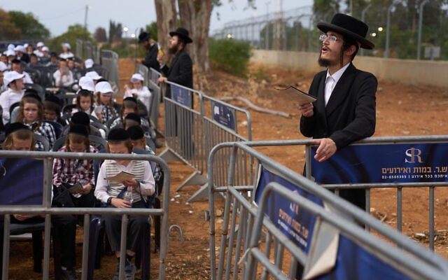 Ultra-Orthodox schoolchildren attend a rally against military conscription and call for the release of detained draft dodgers outside a military prison near Kfar Yona, Israel, October 12, 2026. (AP Photo/Ariel Schalit)