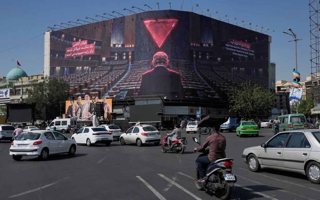 Vehicles drive past a huge billboard depicting Prime Minister Benjamin Netanyahu speaking at the UN General Assembly while seats are empty, referring to some delegations leaving the hall during his address in September, at the Islamic Revolution Square in Tehran, Iran, October 12, 2026. (AP Photo/Vahid Salemi) Vehicles drive past a huge billboard depicting Prime Minister Benjamin Netanyahu speaking at the UN General Assembly while seats are empty, referring to some delegations leaving the hall during his address in September, at the Islamic Revolution Square in Tehran, Iran, October 12, 2026. (AP Photo/Vahid Salemi)