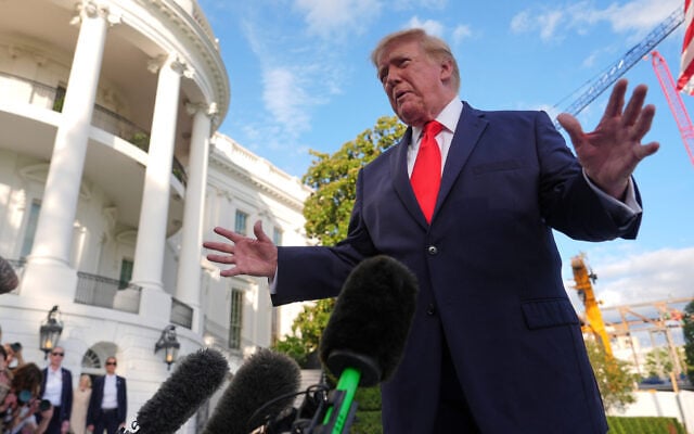 US President Donald Trump speaks with reporters before walking to board Marine One on the South Lawn of the White House, October 12, 2026, in Washington. (AP/Julia Demaree Nikhinson)