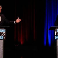 US Rep. Mike Collins, a Republican from Georgia, left, speaks to US Sen. Jon Ossoff, a Democrat from Georgia, during an Atlanta Press Club general election senatorial debate, October 13, 2026, in Atlanta. (AP Photo/Mike Stewart)