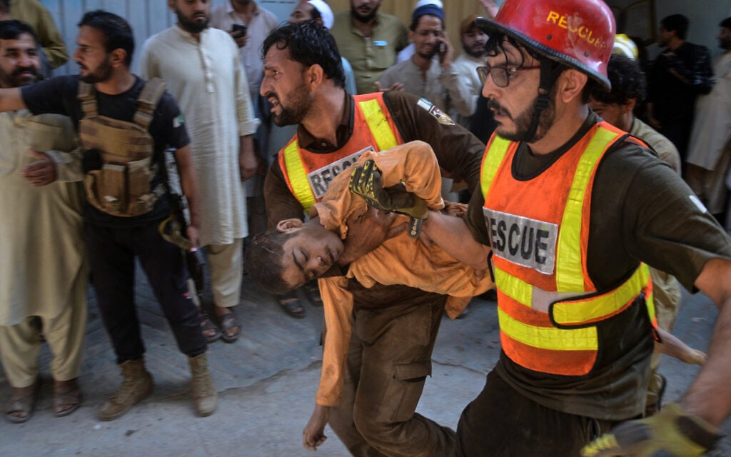 Rescue workers carry an injured boy after rescuing him from the rubble of a roof collapse at a private school, in Peshawar, Pakistan, October 15, 2026. (AP Photo/Muhammad Zubair) Rescue workers carry an injured boy after rescuing him from the rubble of a roof collapse at a private school, in Peshawar, Pakistan, October 15, 2026. (AP Photo/Muhammad Zubair)