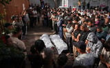 Mourners perform funeral prayers for two Palestinians killed in an Israeli strike targeting a vehicle, at Nasser Hospital in Khan Younis, southern Gaza Strip, October 15, 2026. (AP Photo/Abdel Kareem Hana)