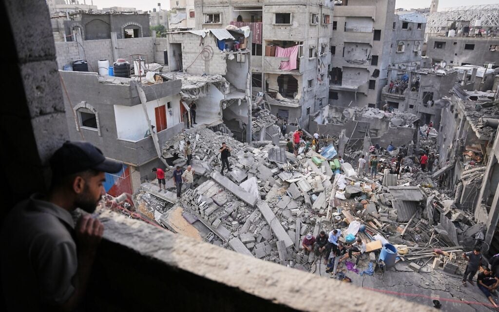 A man looks as Palestinians search through the rubble of a building destroyed in an Israeli airstrike the day before in the Maghazi camp in the central Gaza Strip, October 16, 2026. (AP Photo/Abdel Kareem Hana) A man looks as Palestinians search through the rubble of a building destroyed in an Israeli airstrike the day before in the Maghazi camp in the central Gaza Strip, October 16, 2026. (AP Photo/Abdel Kareem Hana)