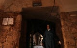 A woman walks beneath a sign that reads in Arabic “Jewish Quarter,” in the old city of Sidon, southern Lebanon, September 25, 2026. (AP Photo/Hassan Ammar)