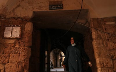 A woman walks beneath a sign that reads in Arabic “Jewish Quarter,” in the old city of Sidon, southern Lebanon, September 25, 2026. (AP Photo/Hassan Ammar) A woman walks beneath a sign that reads in Arabic “Jewish Quarter,” in the old city of Sidon, southern Lebanon, September 25, 2026. (AP Photo/Hassan Ammar)