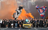 Thousands of members of the Hajduk’s Torcida fan club march toward the stadium ahead of the Conference League soccer match between Hajduk Split and Ajax in Split, Croatia, October 15, 2026. (AP Photo/Ante Cizmic)