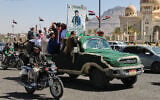 People ride in a pickup truck during a funeral procession for a Houthi officer in Sanaa, Yemen, October 17, 2026. (AP Photo/ Osamah Abdulrahman)