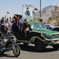 People ride in a pickup truck during a funeral procession for a Houthi officer in Sanaa, Yemen, October 17, 2026. (AP Photo/ Osamah Abdulrahman)