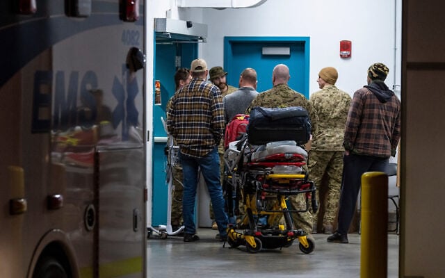 Emergency crews and military personnel are seen at the Wainwright Health Centre as injured military members are treated after a fire at Canadian Forces Base Wainwright, outside of Wainwright, Alberta October 17, 2026. (John Ulan/The Canadian Press via AP)