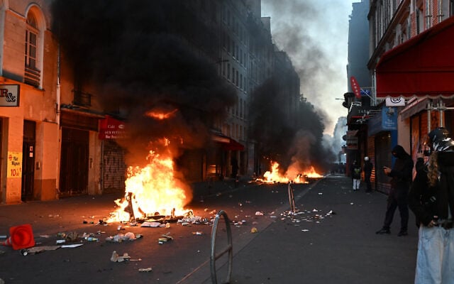 Protesters burn trash during clashes with police the day after a demonstration against rising living costs, joining students’ grievances, in Paris, October 18, 2026. (AP/Emma Da Silva)