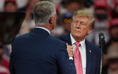 US President Donald Trump greets Republican Senator Roger Marshall of Kansas at a campaign rally at Heartland Credit Union Arena, October 19, 2026, in Park City, Kansas. (AP Photo/Charlie Riedel)