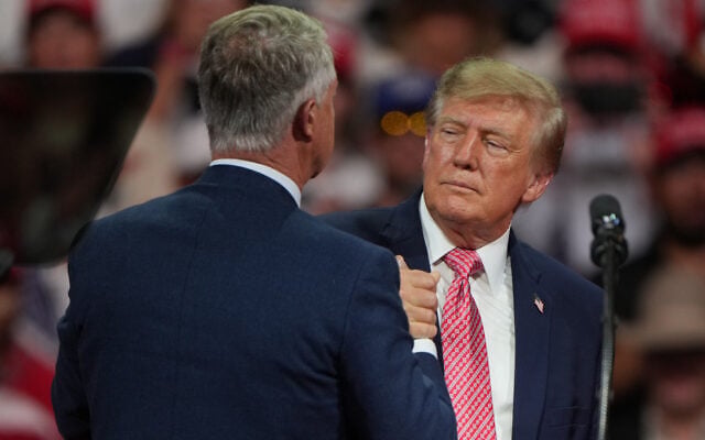 US President Donald Trump greets Republican Senator Roger Marshall of Kansas at a campaign rally at Heartland Credit Union Arena, October 19, 2026, in Park City, Kansas. (AP Photo/Charlie Riedel) US President Donald Trump greets Republican Senator Roger Marshall of Kansas at a campaign rally at Heartland Credit Union Arena, October 19, 2026, in Park City, Kansas. (AP Photo/Charlie Riedel)
