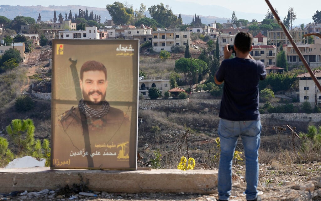 A Lebanese man takes picture by his mobile phone of a village held by Israeli forces, in Zawtar al-Gharbiyeh, southern Lebanon, October 20, 2026. (AP Photo/Hussein Malla) A Lebanese man takes picture by his mobile phone of a village held by Israeli forces, in Zawtar al-Gharbiyeh, southern Lebanon, October 20, 2026. (AP Photo/Hussein Malla)