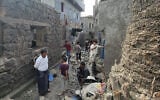 Residents inspect debris of their homes after a missile strike in Seina, Taiz, Yemen, October 20, 2026. (AP Photo/Marzouq Al Jabri)