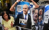 A Likud Party activist holds a campaign banner featuring Prime Minister Benjamin Netanyahu at a market in Tel Aviv, October 22, 2026, ahead of the election. (AP Photo/Ariel Schalit)