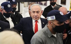 Prime Minister Benjamin Netanyahu, leader of the Likud party, is surrounded by security personnel during a campaign appearance at a market in Tel Aviv, Israel, October 22, 2026, ahead of the country’s general election. (AP Photo/Ariel Schalit)