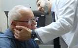 In this image made from video, Tony Hout is examined by Dr. Hussein Tawbi at UT MD Anderson Cancer Center in Houston, Texas, on October 19, 2026. (AP/Lekan Oyekanmi)