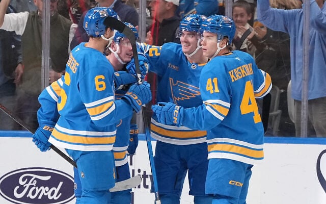 St. Louis Blues’ Justin Barron is congratulated by teammates Philip Broberg (6) and Aleksanteri Kaskimaki (41) after scoring during the first period of an NHL hockey game against the Vegas Golden Knights October 22, 2026, in St. Louis. (AP Photo/Jeff Roberson)