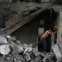 A Palestinian boy makes his way through the rubble of a home destroyed in an overnight Israeli strike in Nuseirat, in the central Gaza Strip, October 23, 2026. (AP Photo/Abdel Kareem Hana)