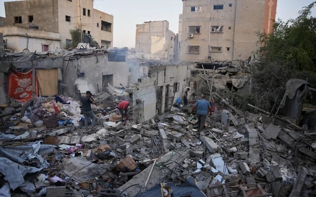 Palestinians search through the rubble of a building destroyed in an overnight Israeli strike in Nuseirat, central Gaza Strip, October 23, 2026. (AP/Abdel Kareem Hana) Palestinians search through the rubble of a building destroyed in an overnight Israeli strike in Nuseirat, central Gaza Strip, October 23, 2026. (AP/Abdel Kareem Hana)