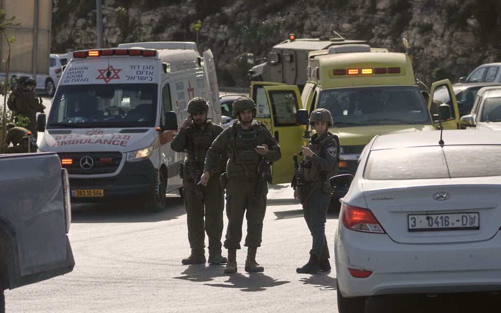 Israeli soldiers and emergency personnel gather near ambulances following a shooting attack carried out by Palestinian gunmen at a junction near Hebron in the West Bank, October 23, 2026. (AP Photo/Mahmoud Illean) Israeli soldiers and emergency personnel gather near ambulances following a shooting attack carried out by Palestinian gunmen at a junction near Hebron in the West Bank, October 23, 2026. (AP Photo/Mahmoud Illean)