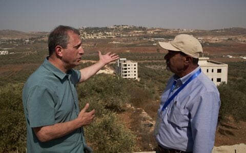 US Democratic congressional candidate Brad Lander (left) speaks with Yasser Alqam (right), spokesperson of the Turmus Ayya municipality, while visiting the West Bank town, October 23, 2026. (AP/Leo Correa)