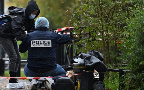 Forensic investigators search for evidence after a shooting in Trappes, outside Paris, October 23, 2026. (AP Photo/Emma Da Silva)