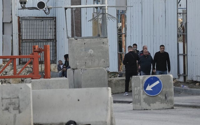 Palestinians cross on foot past a military gate closed to vehicles during an Israeli army operation in Hebron in the West Bank October 24, 2026, a day after a Palestinian shooting attack in the area. (AP Photo/Mahmoud Illean)