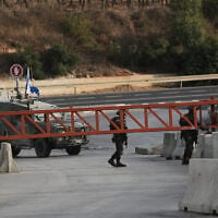 Israeli soldiers close a gate to vehicles during an army operation in Hebron, in the West Bank, October 24, 2026, a day after a Palestinian shooting attack in the area. (AP Photo/Mahmoud Illean)