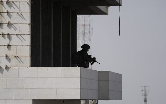 Israeli soldiers take up positions during an army operation in the West Bank city of Hebron October 24, 2026. (AP Photo/Mahmoud Illean)