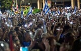Demonstrators hold their phones during an anti-government rally ahead of the country’s general election, October 24, 2026, in Tel Aviv, Israel. (AP Photo/David Goldman)