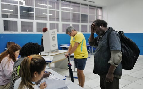 Voters wait to cast their ballots during a presidential runoff in Rio de Janeiro, Brazil, October 25, 2026. (AP Photo/Lucas Landau)