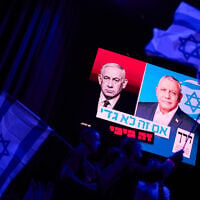 A screen projects an image of Israeli Prime Minister Benjamin Netanyahu, left, and his main rival, opposition candidate Gadi Eisenkot, leader of the Yashar party, during a campaign rally for Eisenkot ahead of Israel’s general election, October 25, 2026, in Tel Aviv, Israel. (AP Photo/David Goldman)