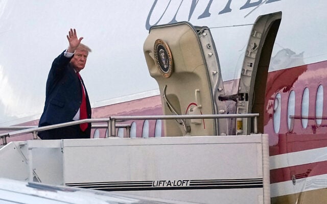 US President Donald Trump waves as he boards Air Force One, October 25, 2026, at Selfridge Air National Guard Base, Mich. (AP Photo/Julia Demaree Nikhinson)