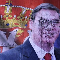 A defaced poster of Aleksandar Vucic, leader of the right-wing Serbian Progressive Party (SNS), lies on the pavement outside the National Assembly, after he conceded defeat in the parliamentary election in Belgrade, Serbia, October 25, 2026. (AP Photo/Armin Durgut)