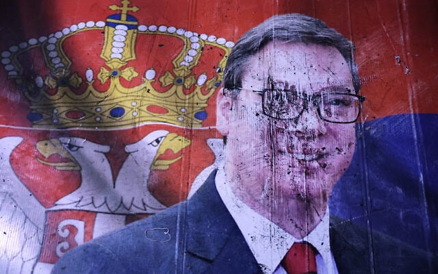 A defaced poster of Aleksandar Vucic, leader of the right-wing Serbian Progressive Party (SNS), lies on the pavement outside the National Assembly, after he conceded defeat in the parliamentary election in Belgrade, Serbia, October 25, 2026. (AP Photo/Armin Durgut)
