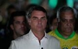 Opposition presidential candidate Sen. Flavio Bolsonaro arrives at his election night event after the presidential runoff in Brasilia, Brazil, October 25, 2026. (AP Photo/Eraldo Peres)