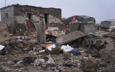 A man inspects the aftermath of a Jordanian airstrike in Al-Tuff, in the countryside of Daraa province in southern Syria, October 27, 2026. (AP Photo/Ghaith Alsayed)