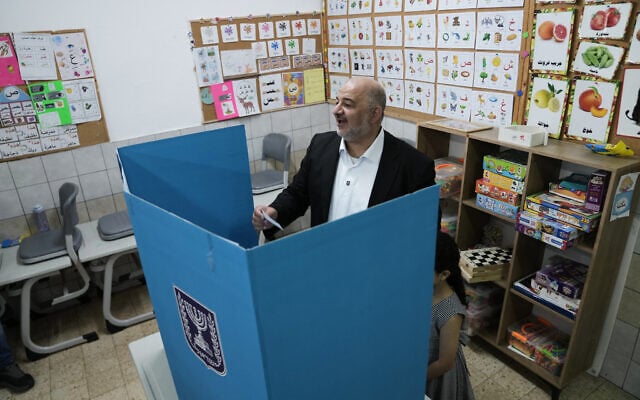 Ra'am party leader Mansour Abbas casts his ballot alongside his daughter during Israel’s general election at a polling station in Maghar, October 27, 2026. (AP Photo/Mahmoud Illean)