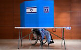A patient on a wheelchair casts his ballot at a polling station at Rambam Hospital during the election in Haifa, October 27, 2026. (AP/Baz Ratner)