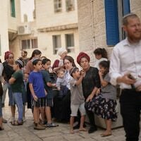 Israeli settlers gather with their children outside a polling station during Israel’s general election in Hebron in the West Bank, October 27, 2026. (AP Photo/Leo Correa)