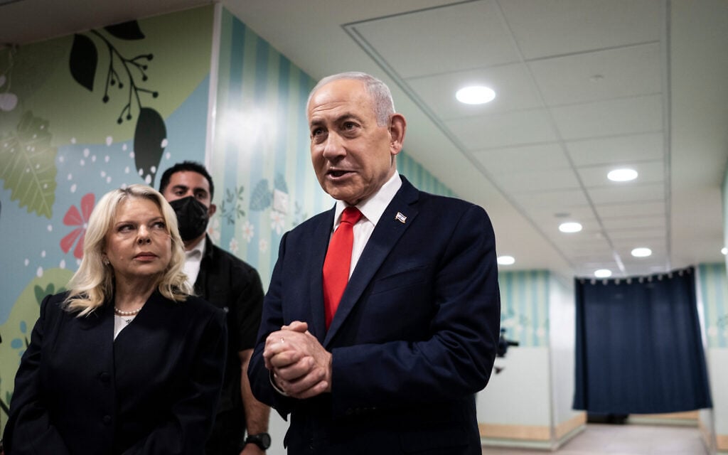 Prime Minister Benjamin Netanyahu speaks to the media as he stands next to his wife Sara after voting at a polling station in Jerusalem, October 27, 2026. (Jewel Samad/Pool Photo via AP) Prime Minister Benjamin Netanyahu speaks to the media as he stands next to his wife Sara after voting at a polling station in Jerusalem, October 27, 2026. (Jewel Samad/Pool Photo via AP)